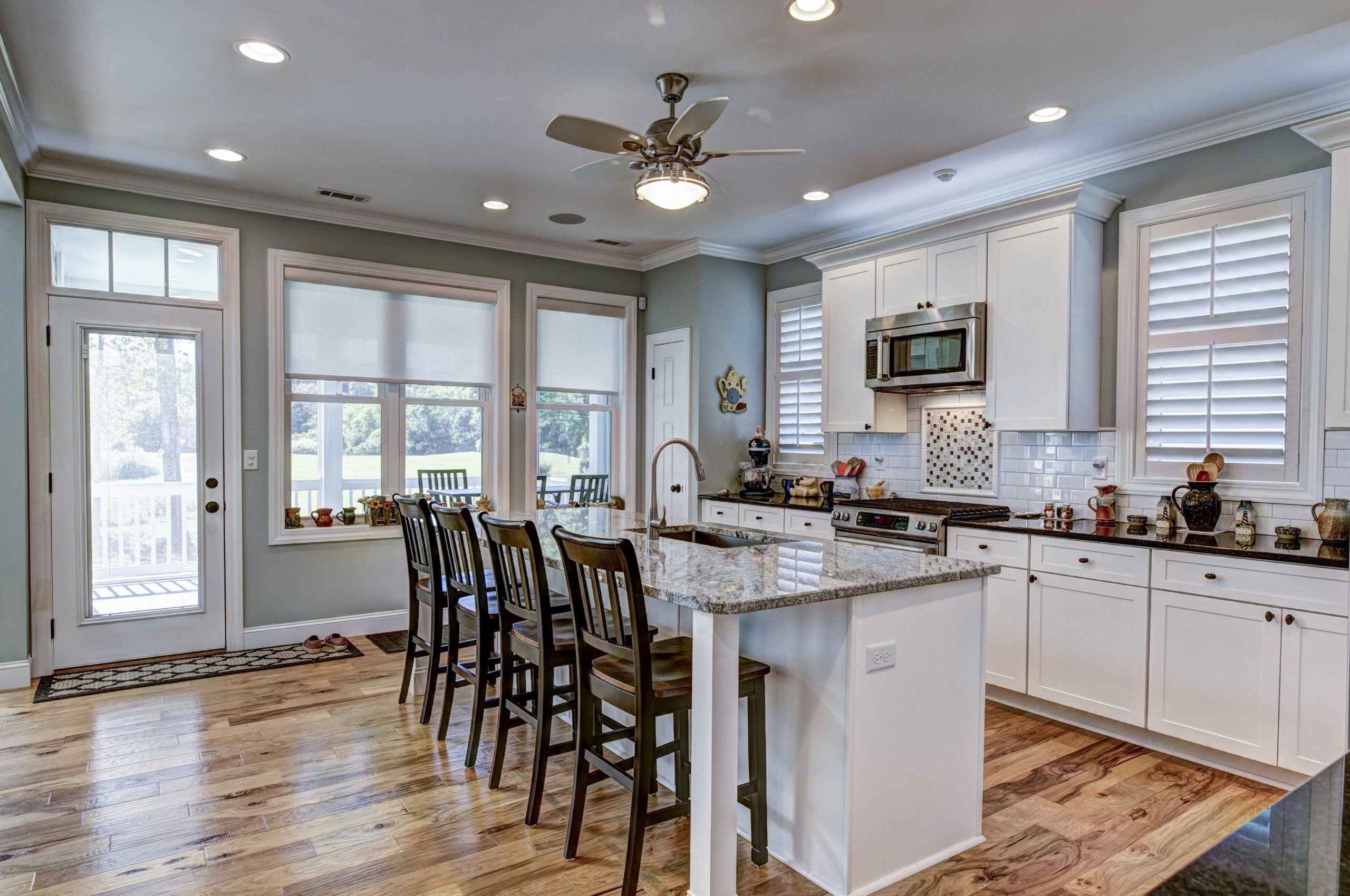 Kitchen interior with white cabinets and warm hardwood flooring