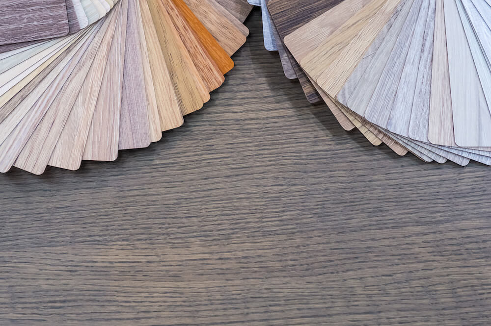 Wood stain and plank sample fans on a finished floor